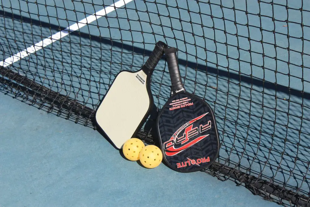 you lean the rackets against the net on the court